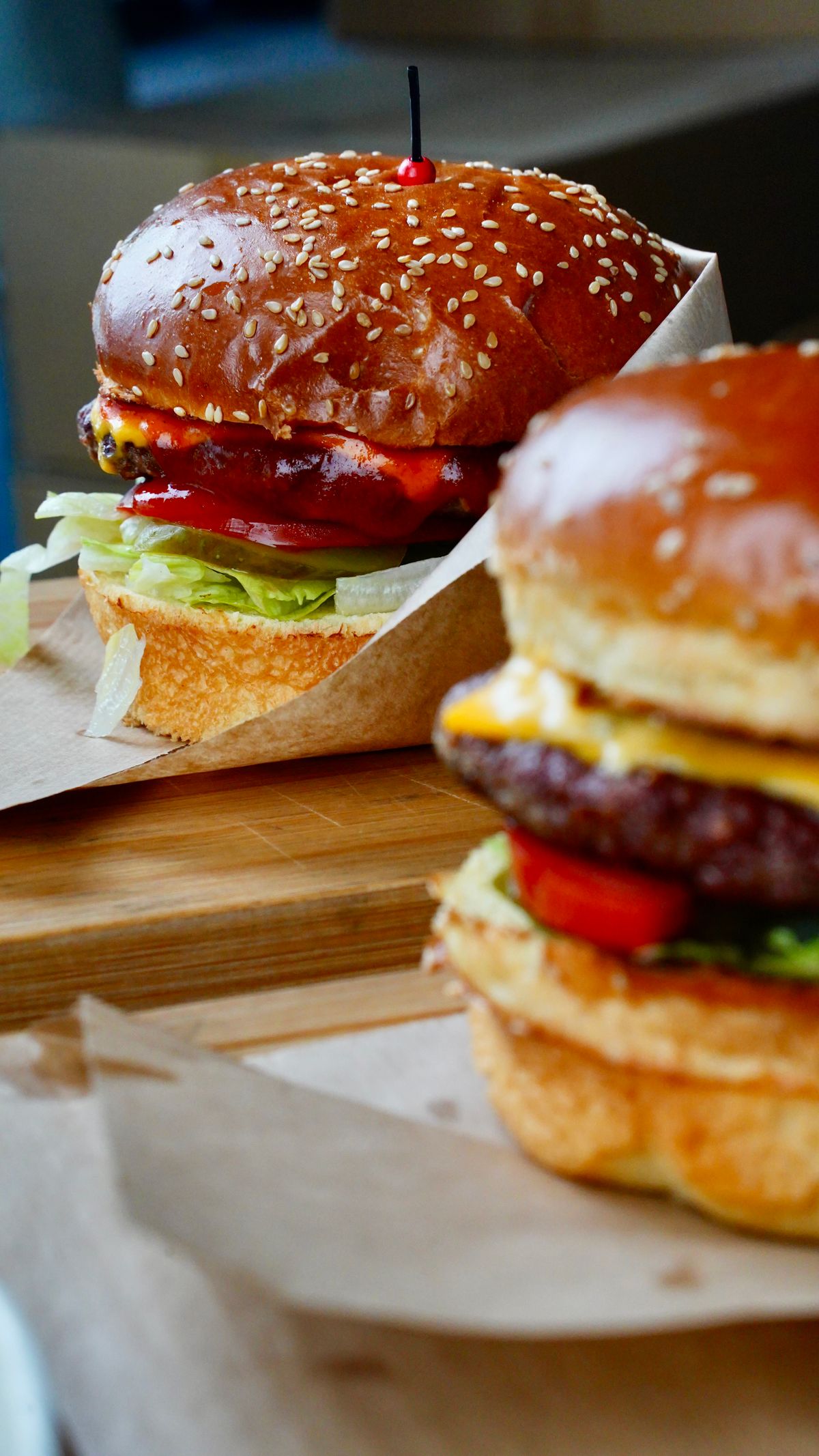 Two freshly prepared burgers on a counter